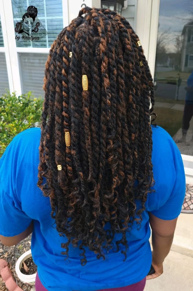 Marley twists in black with brown highlights and gold cuffs, back view