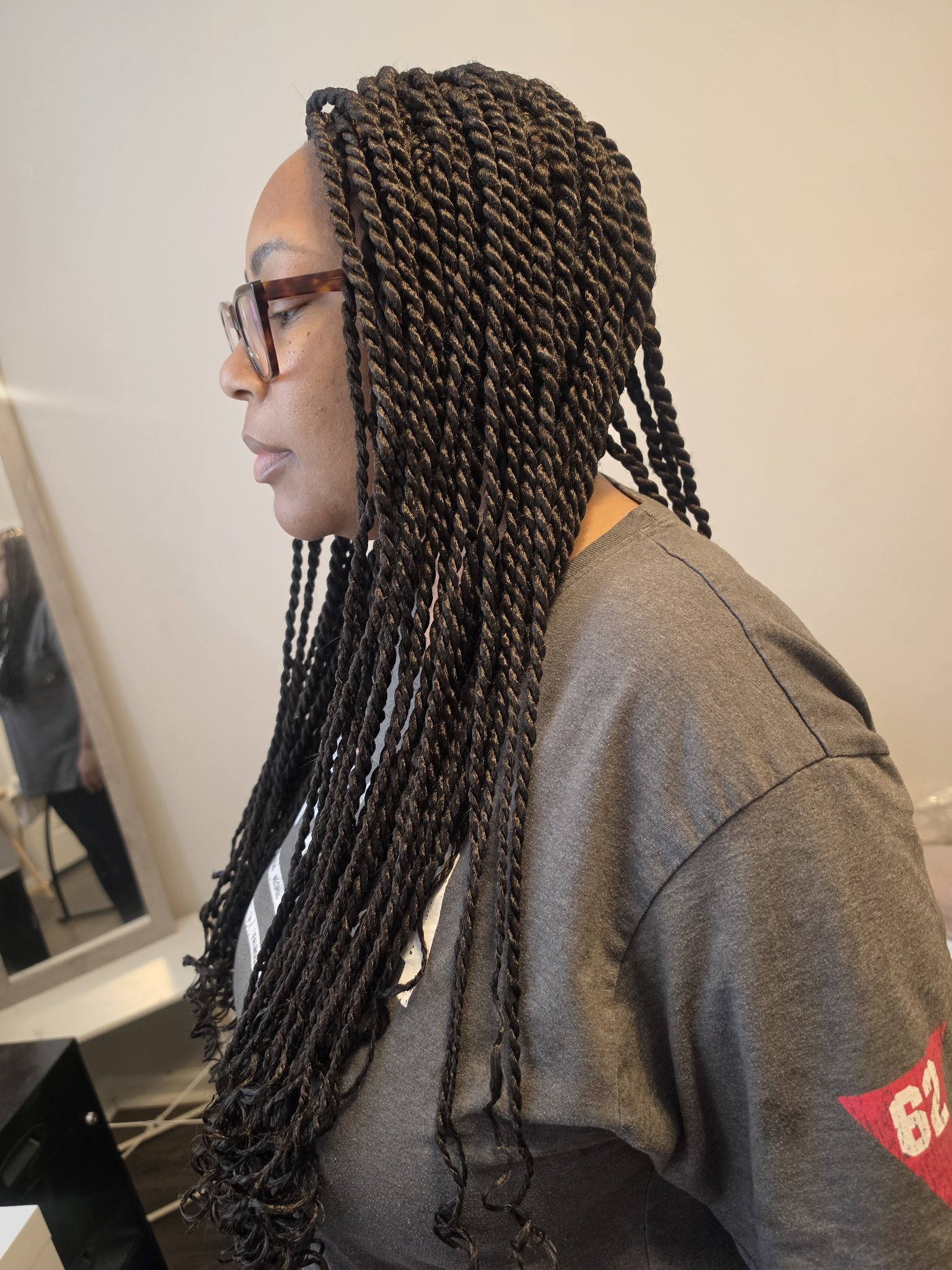 Long Senegalese twists in black, side profile view