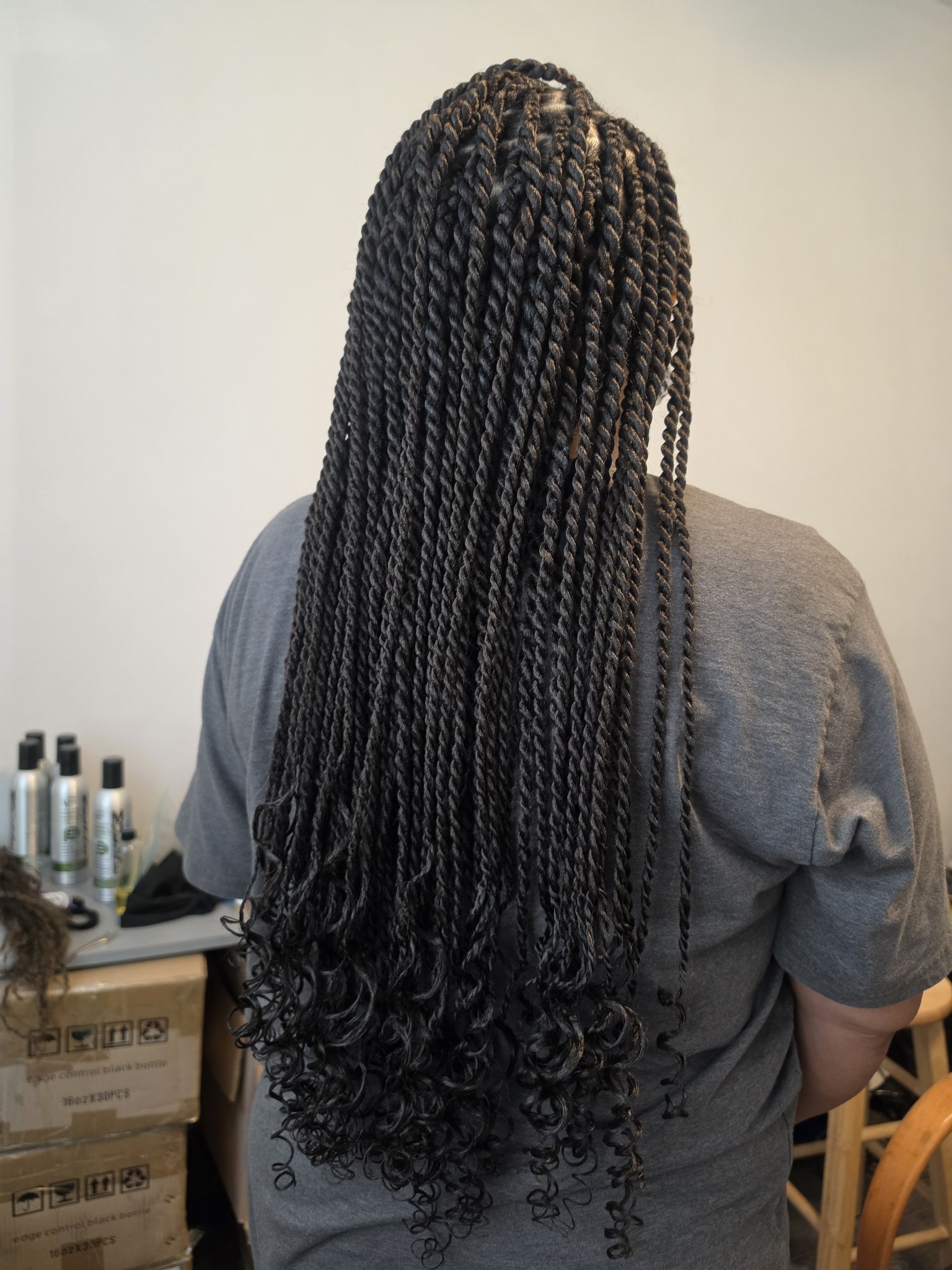 Long Senegalese twists seen from behind with curly ends