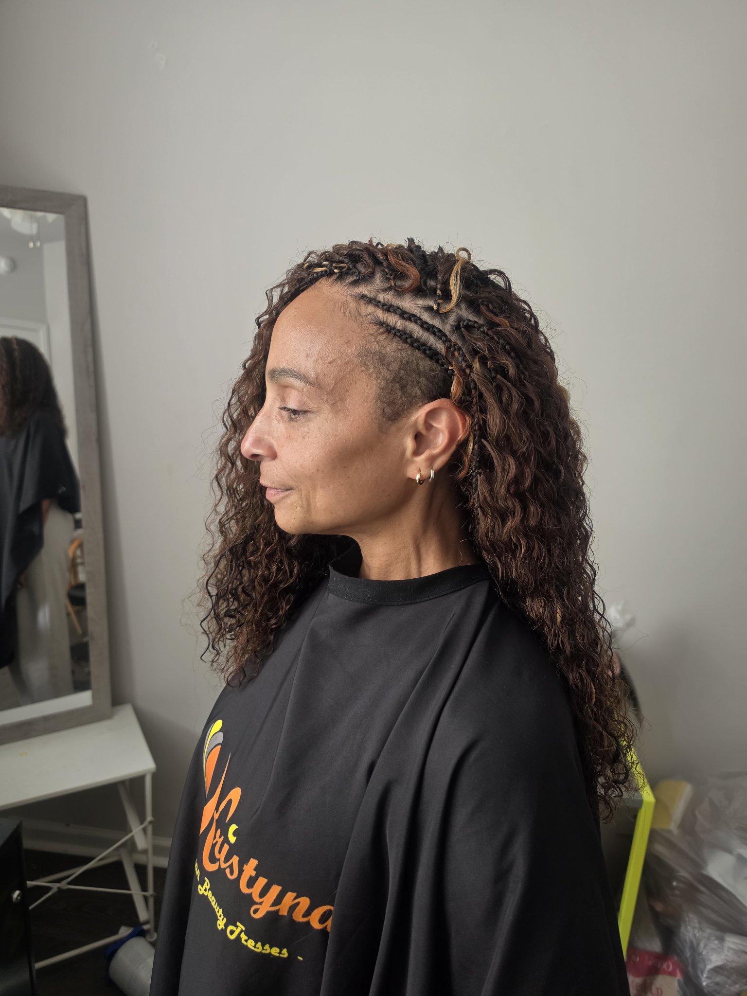 Side braids with loose curly hair, side profile view