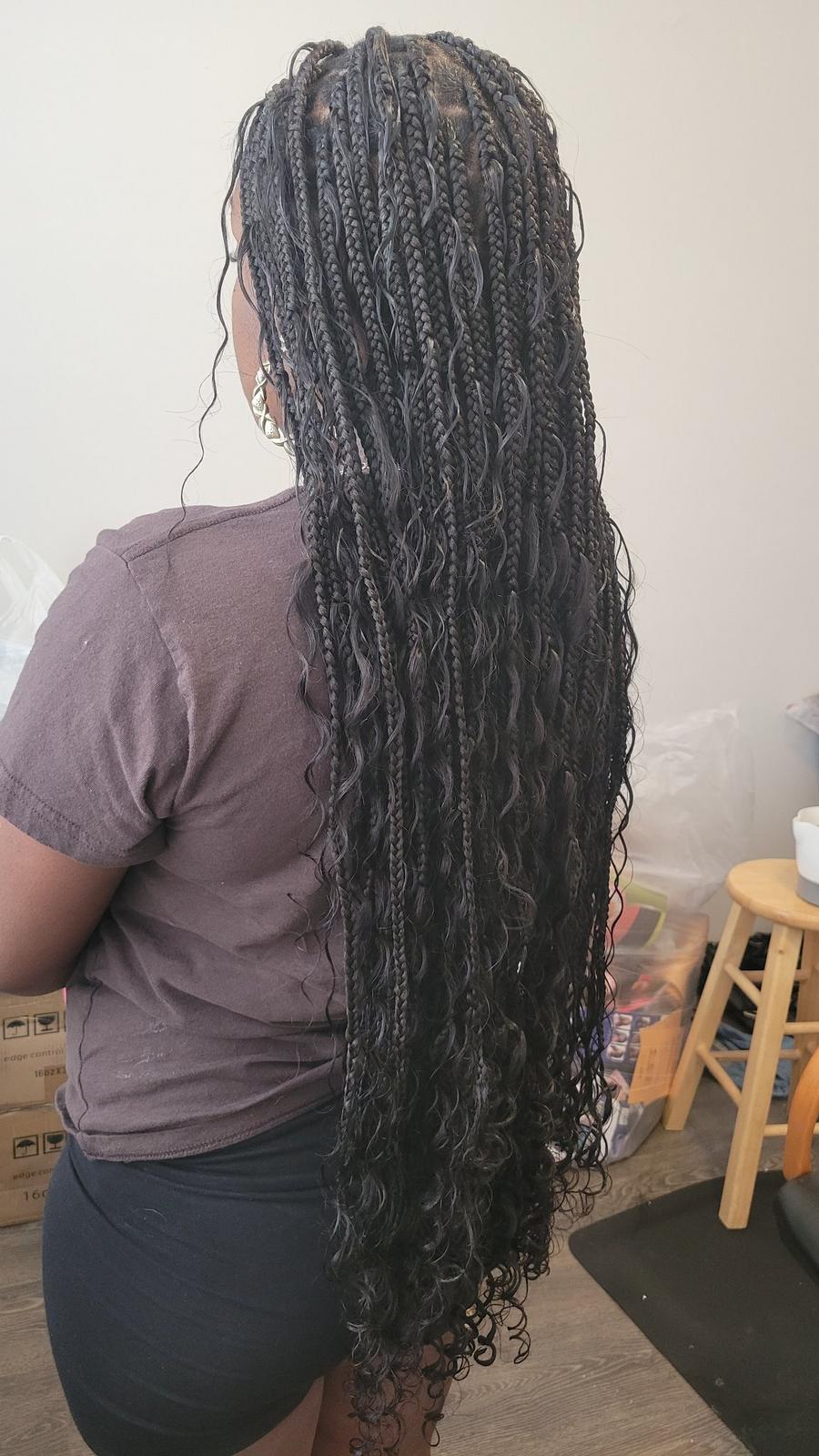 Long boho knotless braids in black with curly ends, back view