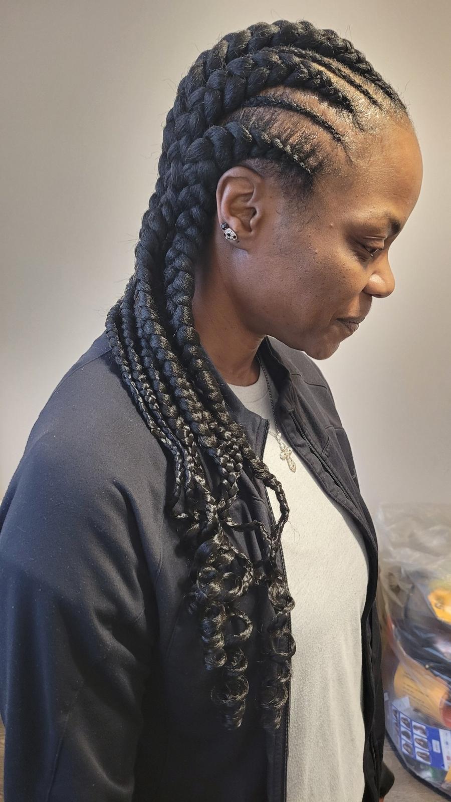 Feed-in cornrows in black with curly ends, side view